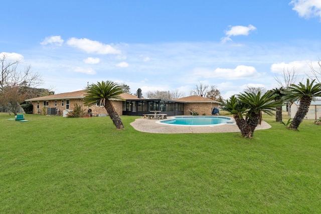 view of pool with a patio area, central air condition unit, and a lawn