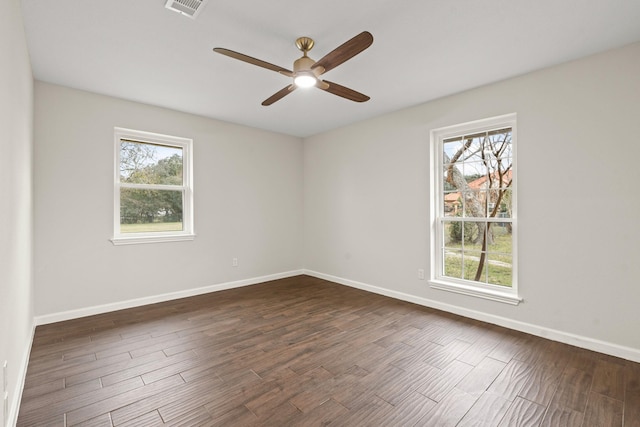 empty room featuring ceiling fan and dark hardwood / wood-style flooring