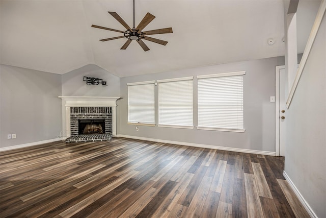 unfurnished living room featuring dark hardwood / wood-style floors, lofted ceiling, plenty of natural light, a fireplace, and ceiling fan