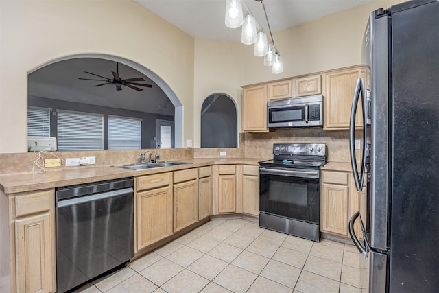 kitchen featuring stainless steel appliances, sink, light brown cabinets, ceiling fan, and decorative backsplash