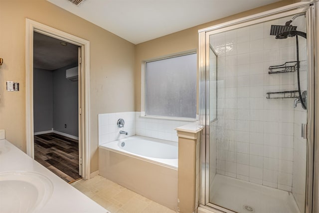 bathroom with vanity, tile patterned floors, a wall mounted air conditioner, and plus walk in shower