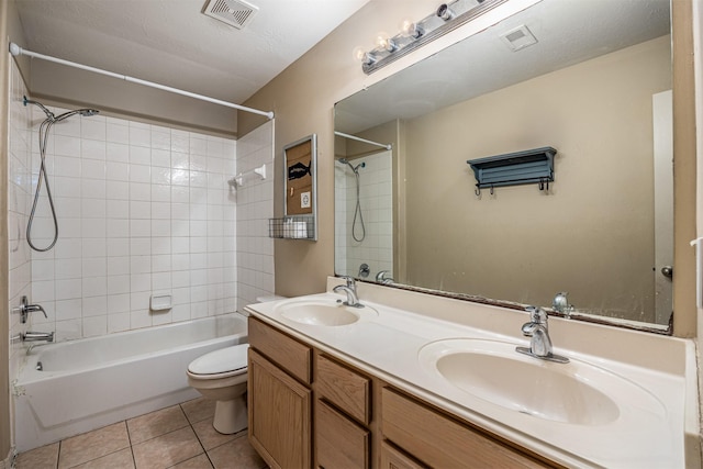 full bathroom with toilet, tiled shower / bath combo, tile patterned floors, and vanity