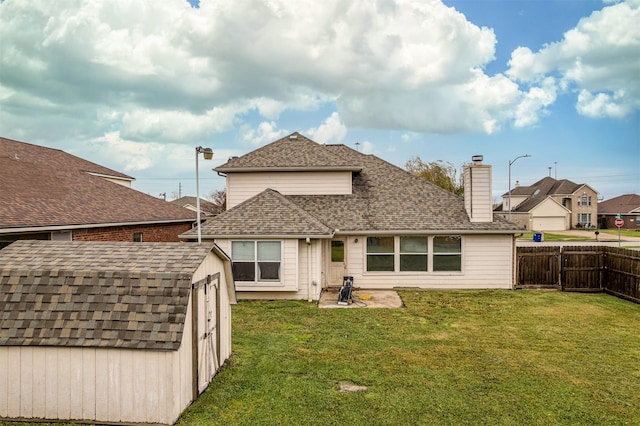 rear view of house with a yard, a storage shed, and a patio area