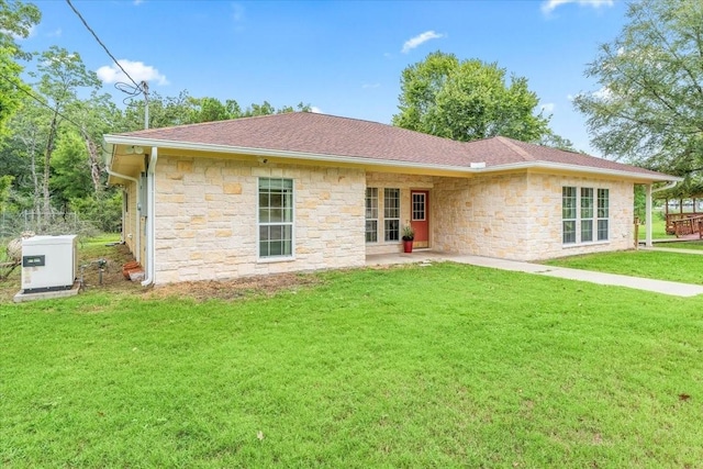 back of property featuring a yard