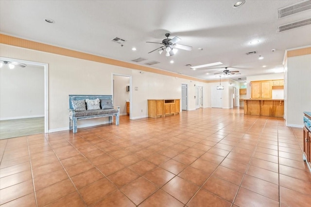 unfurnished living room with light tile patterned floors and ornamental molding