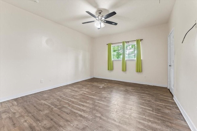 spare room featuring ceiling fan and hardwood / wood-style floors