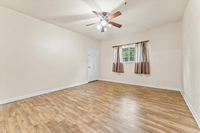 spare room featuring ceiling fan and light hardwood / wood-style flooring