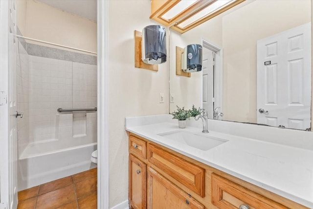 full bathroom featuring vanity, bathing tub / shower combination, tile patterned floors, a skylight, and toilet