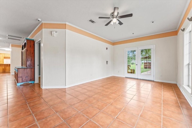 tiled empty room featuring ceiling fan and crown molding