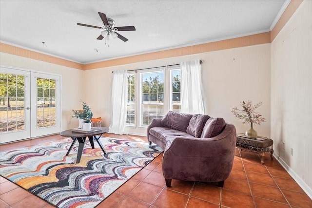 tiled living room with french doors, a wealth of natural light, ornamental molding, and ceiling fan