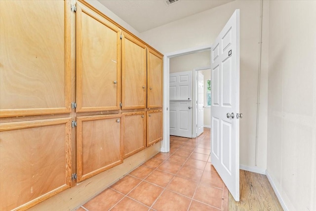 corridor with light tile patterned floors