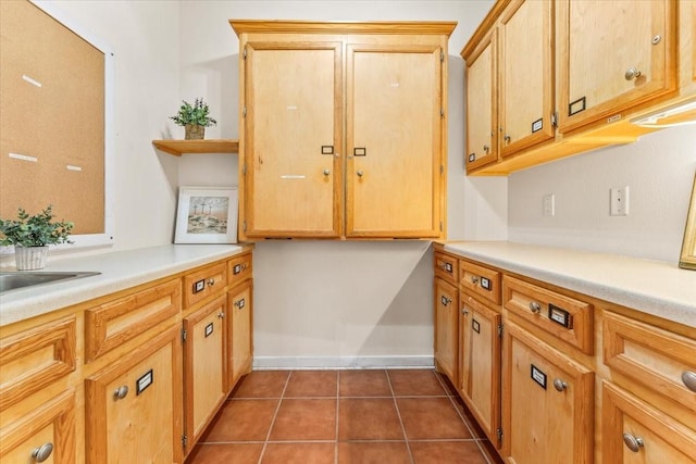 kitchen featuring dark tile patterned floors