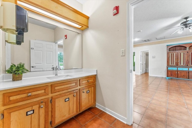 bathroom featuring tile patterned floors, ceiling fan, vanity, and a textured ceiling