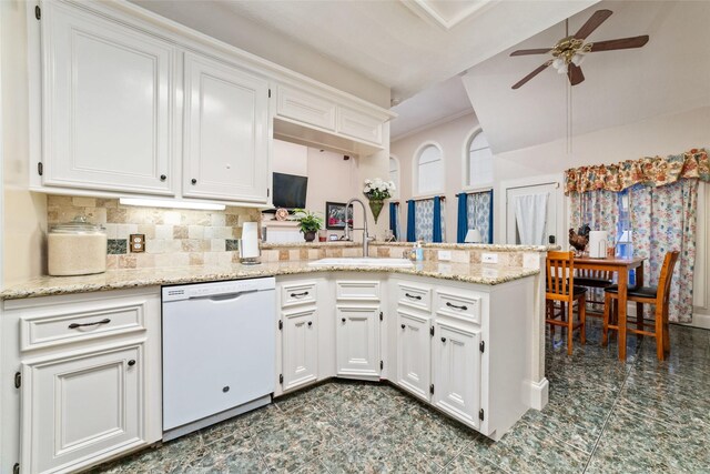 kitchen with kitchen peninsula, white dishwasher, ceiling fan, sink, and white cabinets