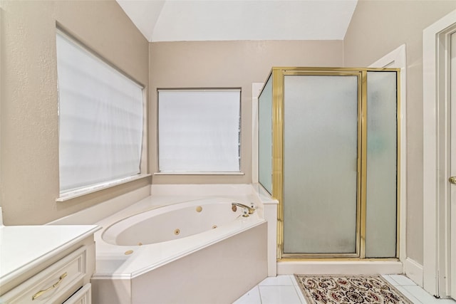 bathroom featuring tile patterned flooring, vanity, shower with separate bathtub, and vaulted ceiling