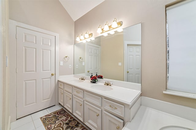 bathroom with tile patterned floors, vanity, and vaulted ceiling