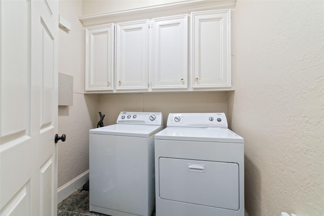 washroom featuring cabinets and independent washer and dryer