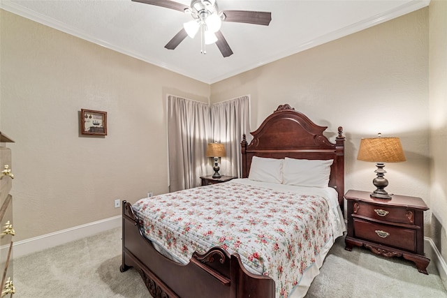 bedroom with ceiling fan, crown molding, and light colored carpet