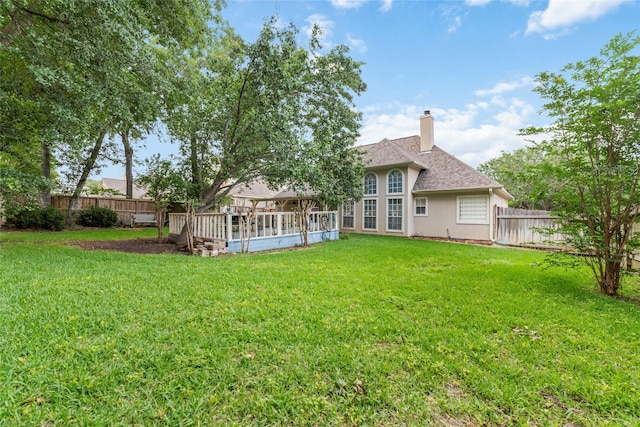 back of house with a yard and a deck