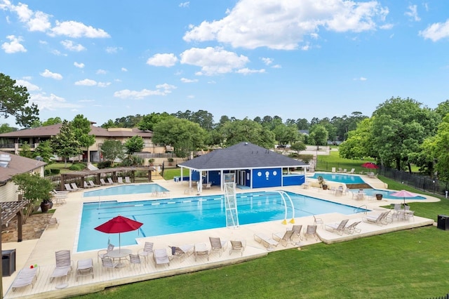 view of swimming pool with a lawn and a patio area