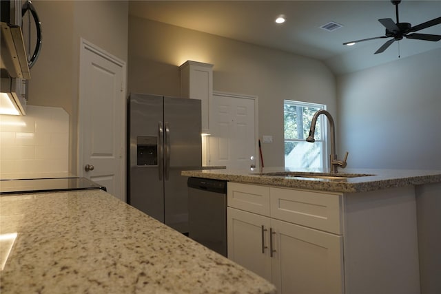 kitchen with appliances with stainless steel finishes, white cabinetry, ceiling fan, and sink