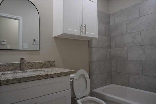 full bathroom with vanity, toilet, and tiled shower / bath combo