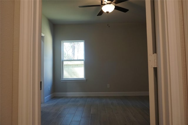 unfurnished room featuring ceiling fan and dark hardwood / wood-style floors