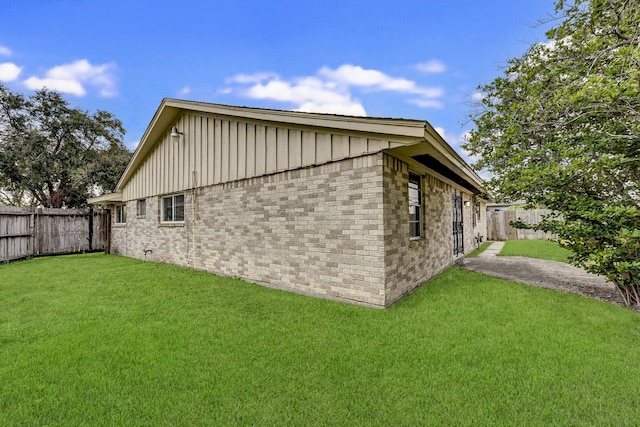 view of side of property with a yard