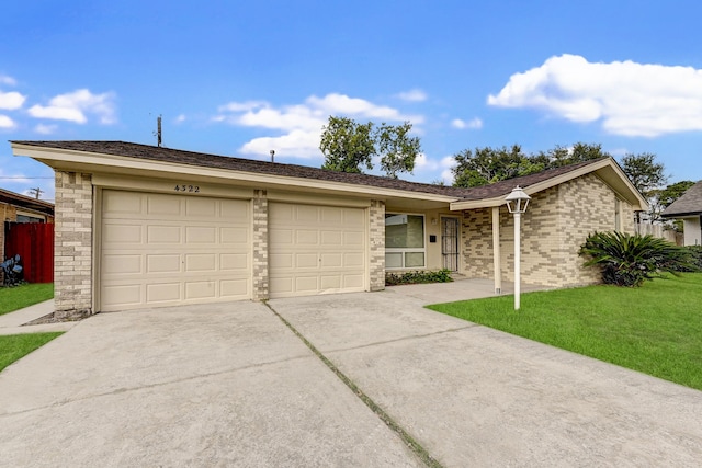 single story home featuring a front yard and a garage