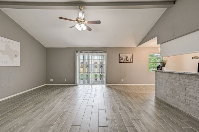 unfurnished living room with lofted ceiling with beams and ceiling fan