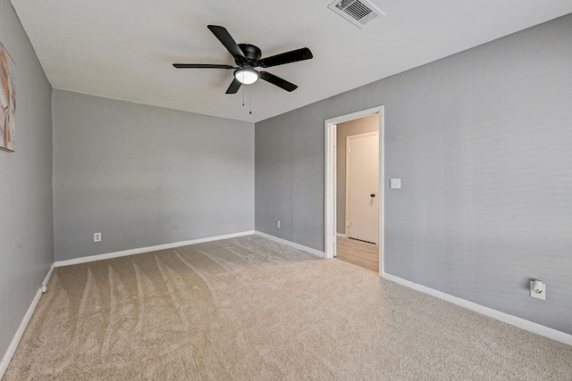 unfurnished room featuring light colored carpet and ceiling fan