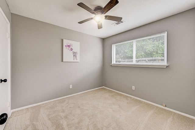 unfurnished room with light carpet and ceiling fan