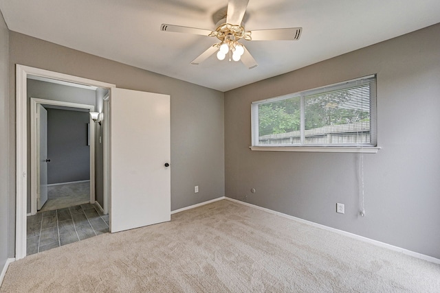 unfurnished bedroom with light colored carpet and ceiling fan