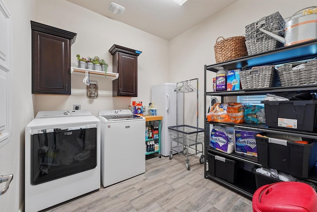 washroom with cabinets and washer and clothes dryer