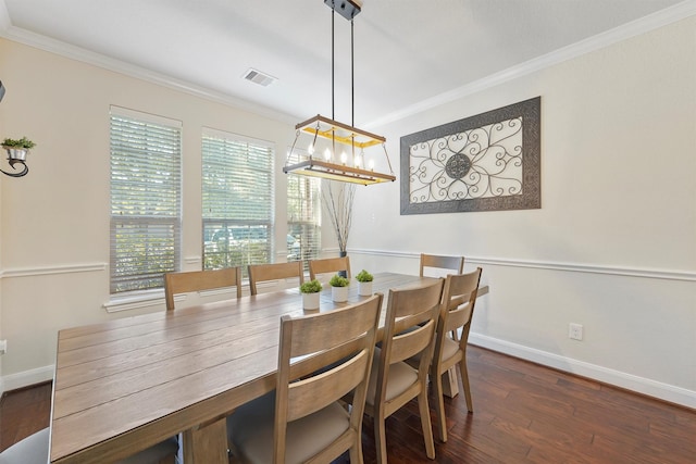 dining space featuring ornamental molding and dark wood-type flooring