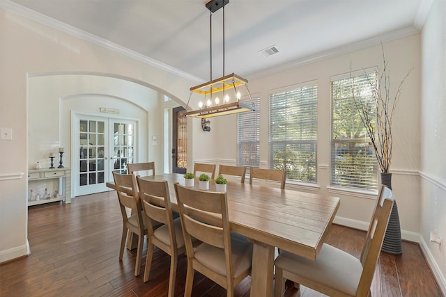 dining room with ornamental molding, french doors, and dark wood-type flooring