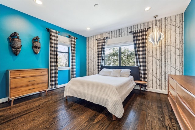 bedroom with dark hardwood / wood-style floors