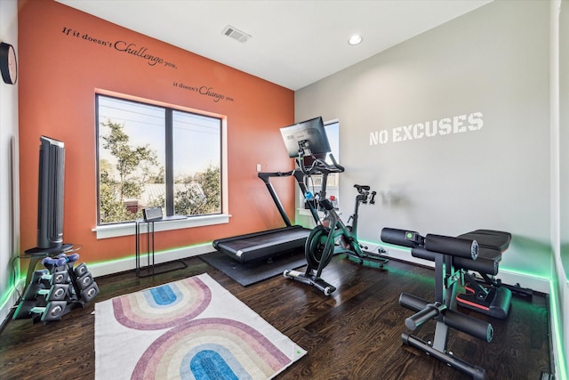 exercise room with dark wood-type flooring