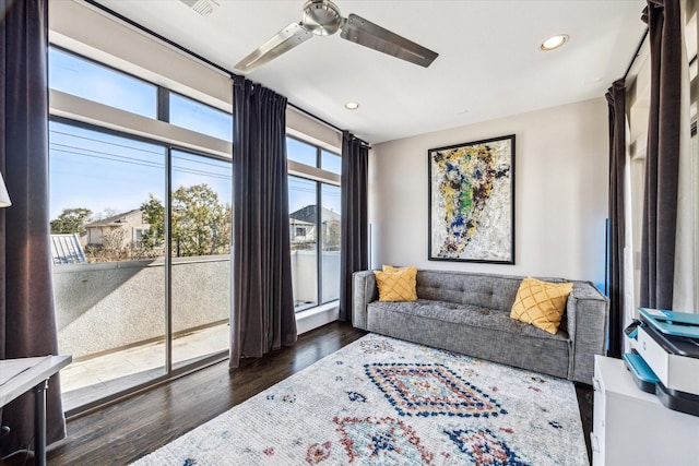 living room featuring ceiling fan and dark hardwood / wood-style floors