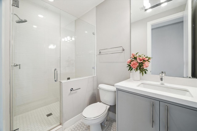 bathroom featuring toilet, tile patterned flooring, a shower with door, and vanity