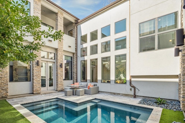 rear view of house featuring an outdoor hangout area, a patio, and french doors