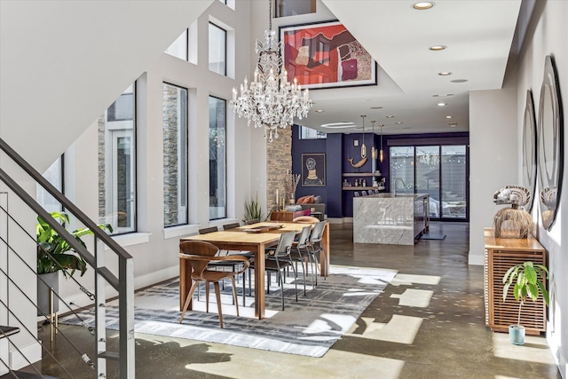 dining room featuring sink and a notable chandelier