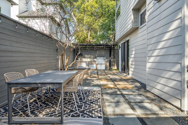 view of patio with a grill and an outdoor kitchen