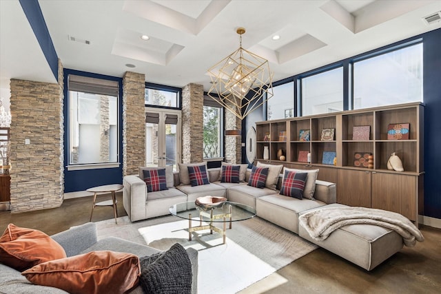 living room featuring an inviting chandelier, concrete floors, french doors, and plenty of natural light