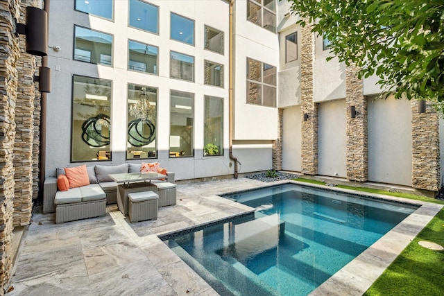 view of pool with a hot tub, outdoor lounge area, and a patio area