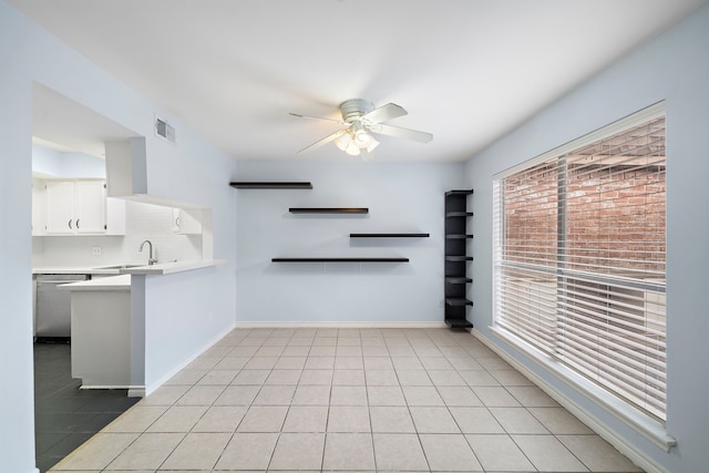 interior space featuring ceiling fan, light tile patterned floors, and sink