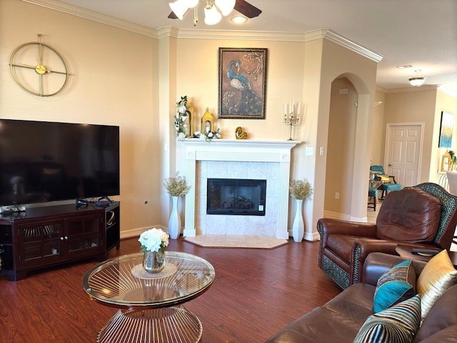 living room featuring a fireplace, dark hardwood / wood-style floors, and crown molding