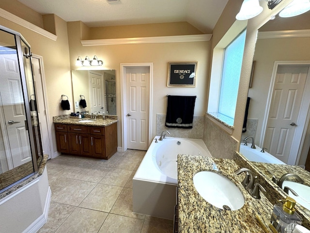 bathroom with tile patterned flooring, vanity, independent shower and bath, and vaulted ceiling