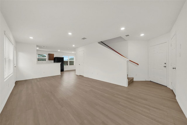 unfurnished living room with light hardwood / wood-style floors