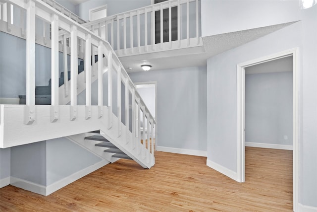 staircase featuring wood-type flooring